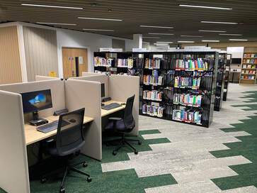 Photograph of the library showing PCs and bookshelves