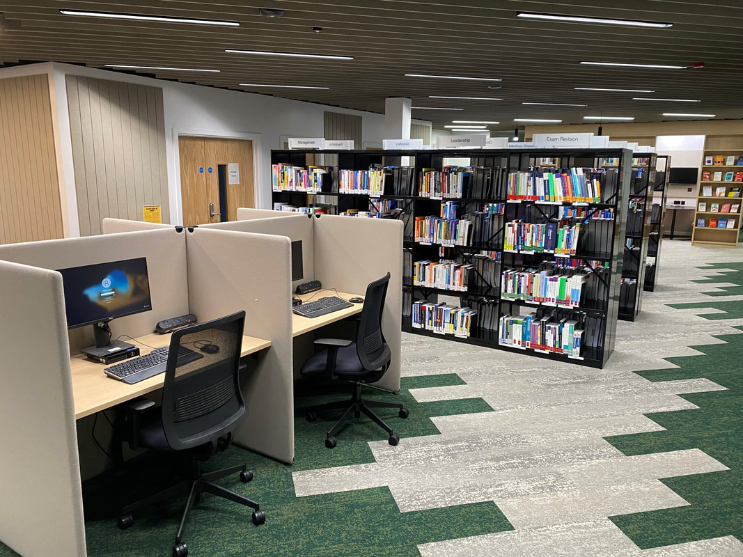 Photo of the LEAD Hub computer desks and book shelves